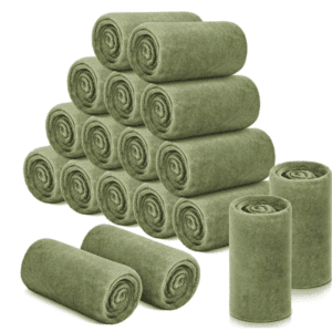A group of rolled up green blankets stacked on top of each other.